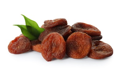 Photo of Tasty dried apricots and leaves on white background