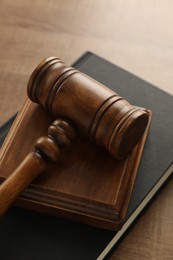 Photo of Law concept. Gavel and book on wooden table, closeup