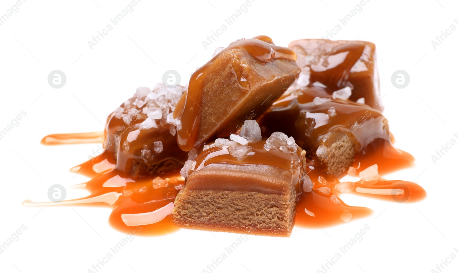 Photo of Delicious salted caramel with sauce on white background