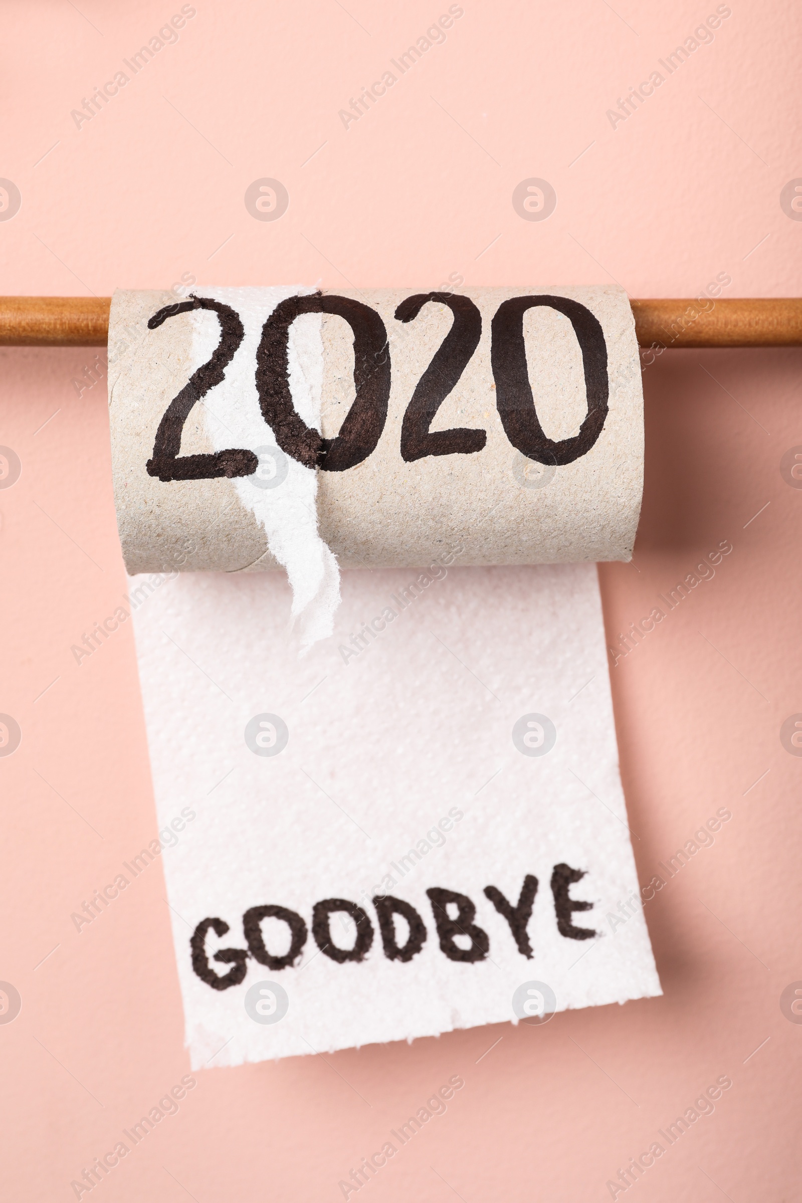 Photo of Toilet paper roll with text Goodbye 2020 on pink background