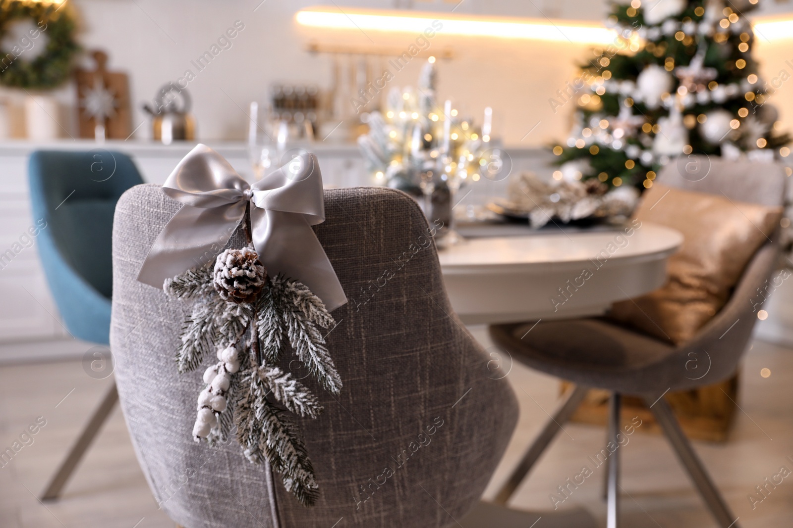 Photo of Grey chair with beautiful Christmas decor in kitchen. Interior design