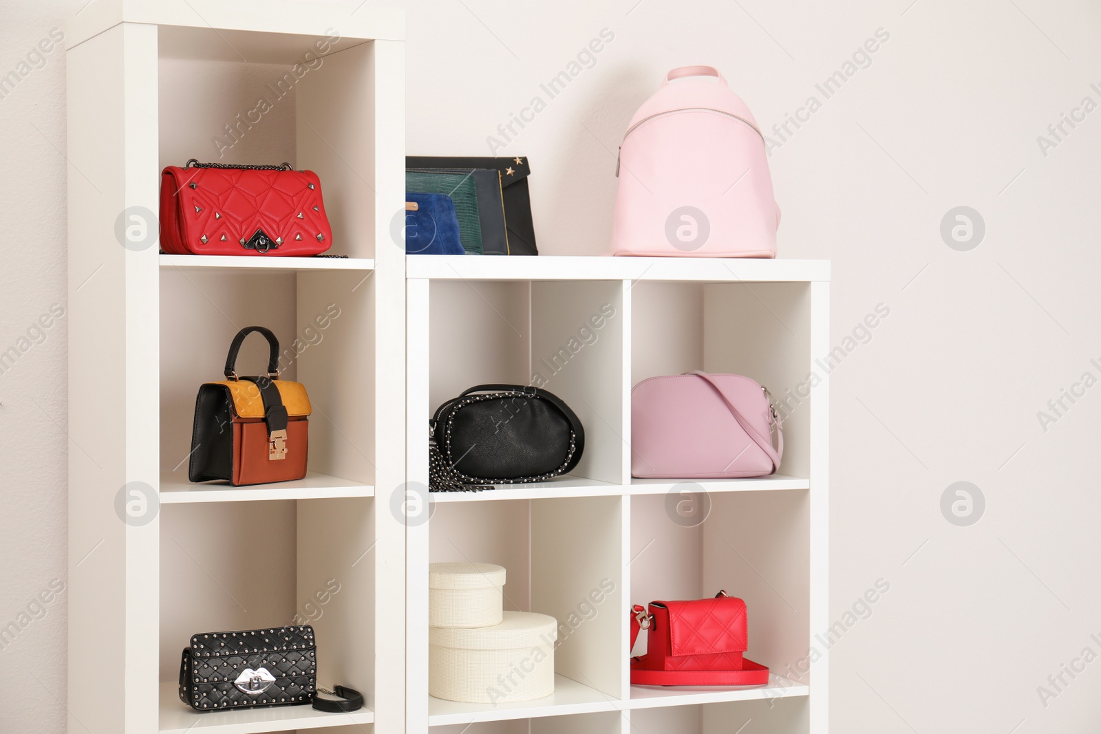 Photo of Wardrobe shelves with different stylish bags indoors. Idea for interior design