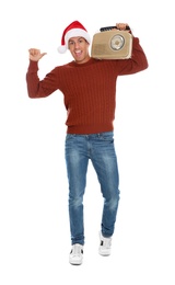 Photo of Emotional man with vintage radio on white background. Christmas music