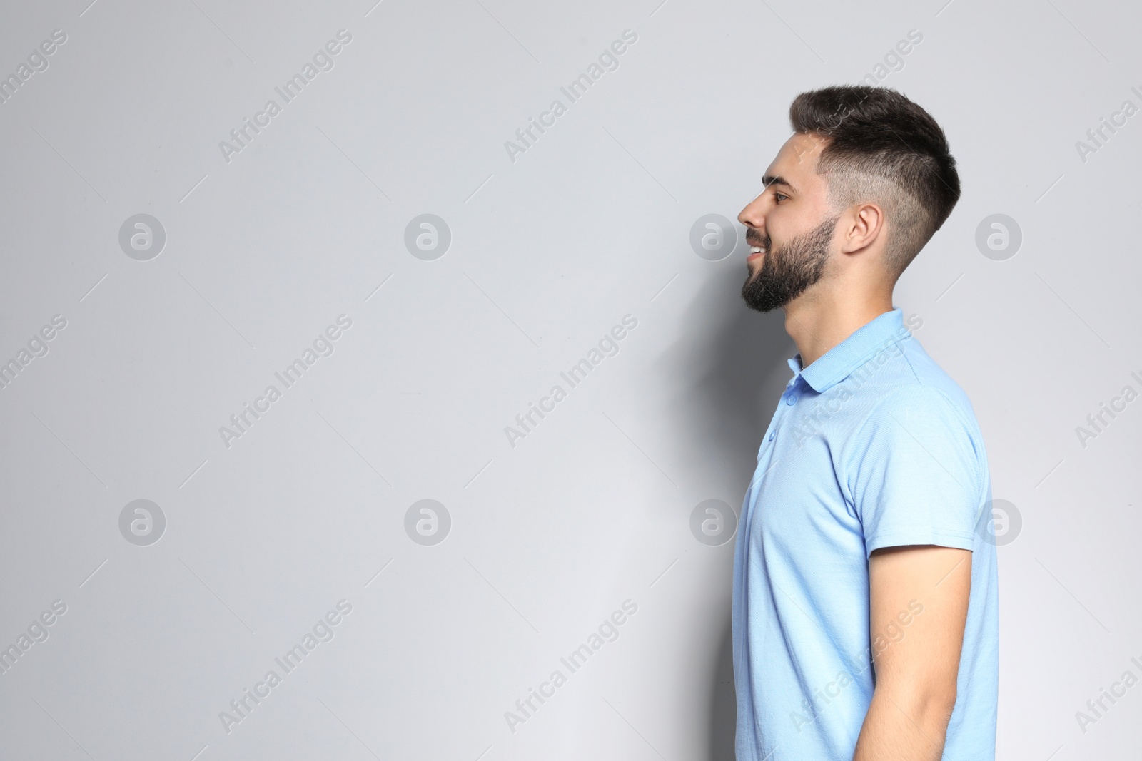 Photo of Portrait of handsome young man against light background. Space for text