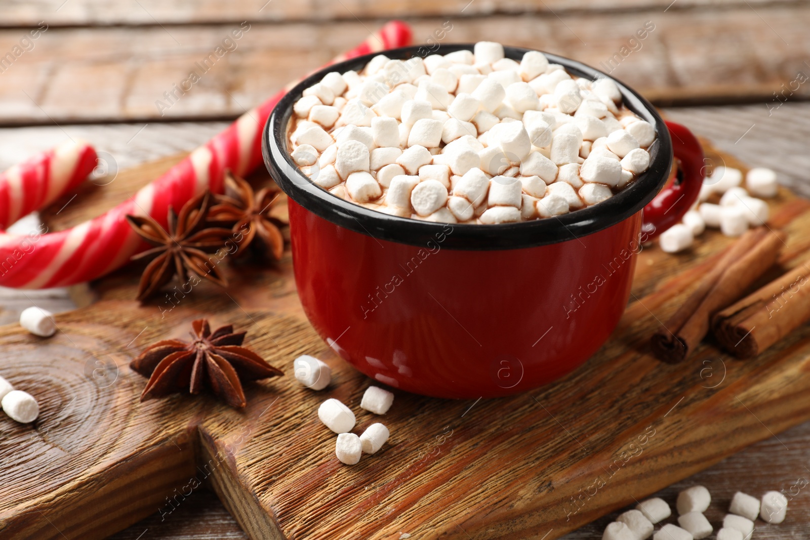 Photo of Tasty hot chocolate with marshmallows on wooden table, closeup