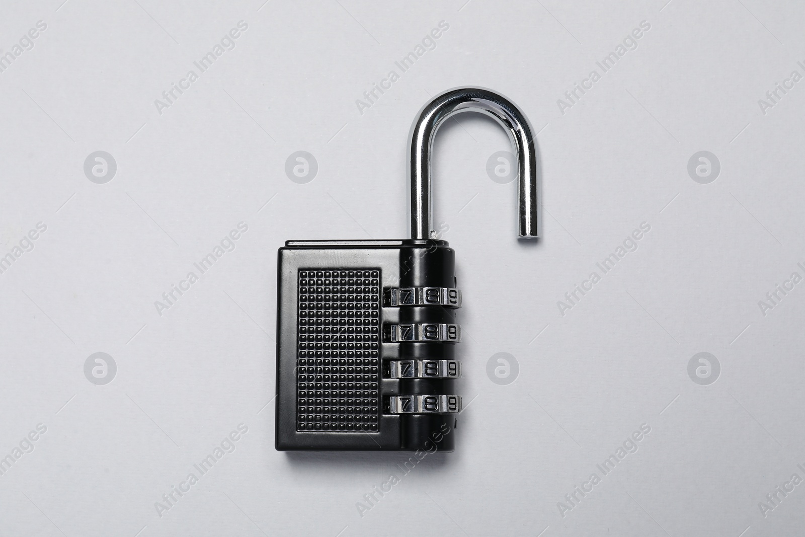 Photo of One steel combination padlock on grey background, top view