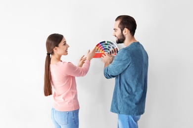 Photo of Young couple with color palette on white background