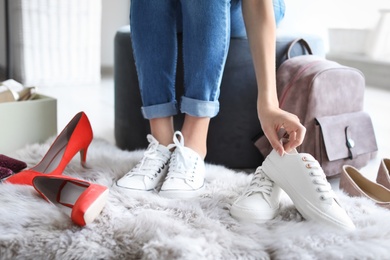 Young woman trying on shoes in store