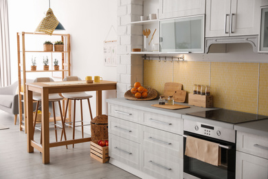 Photo of Modern kitchen interior with stylish wooden table