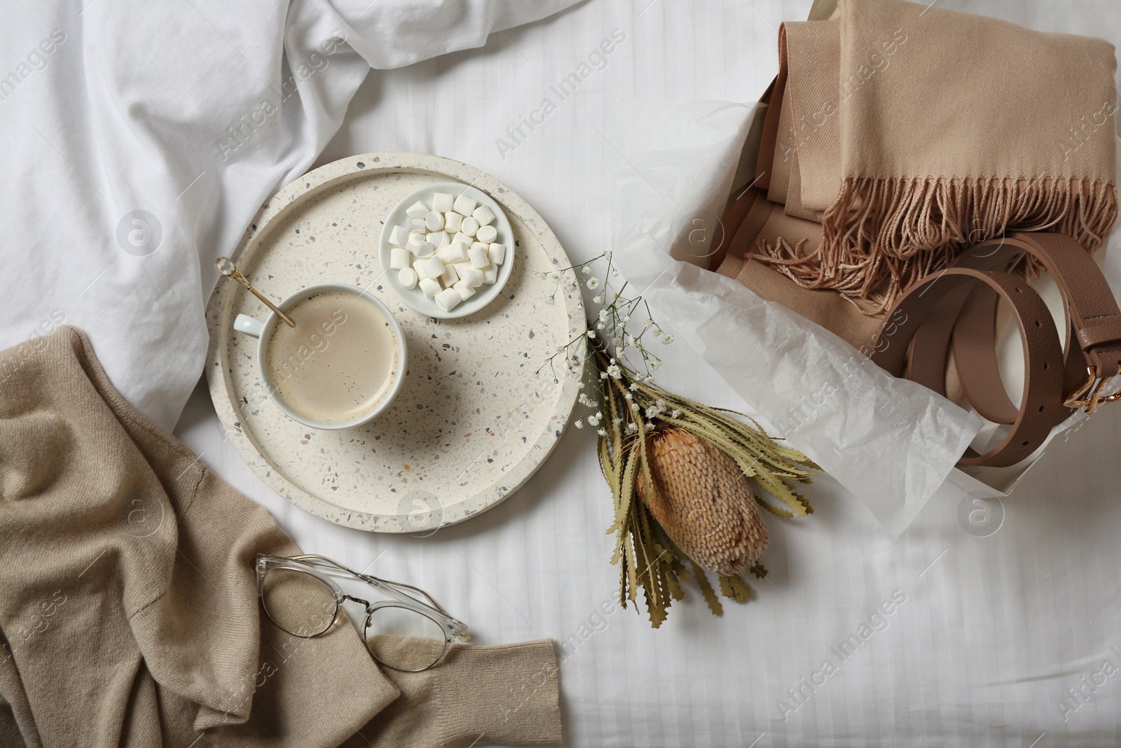 Photo of Flat lay composition with soft cashmere sweater on bed at home