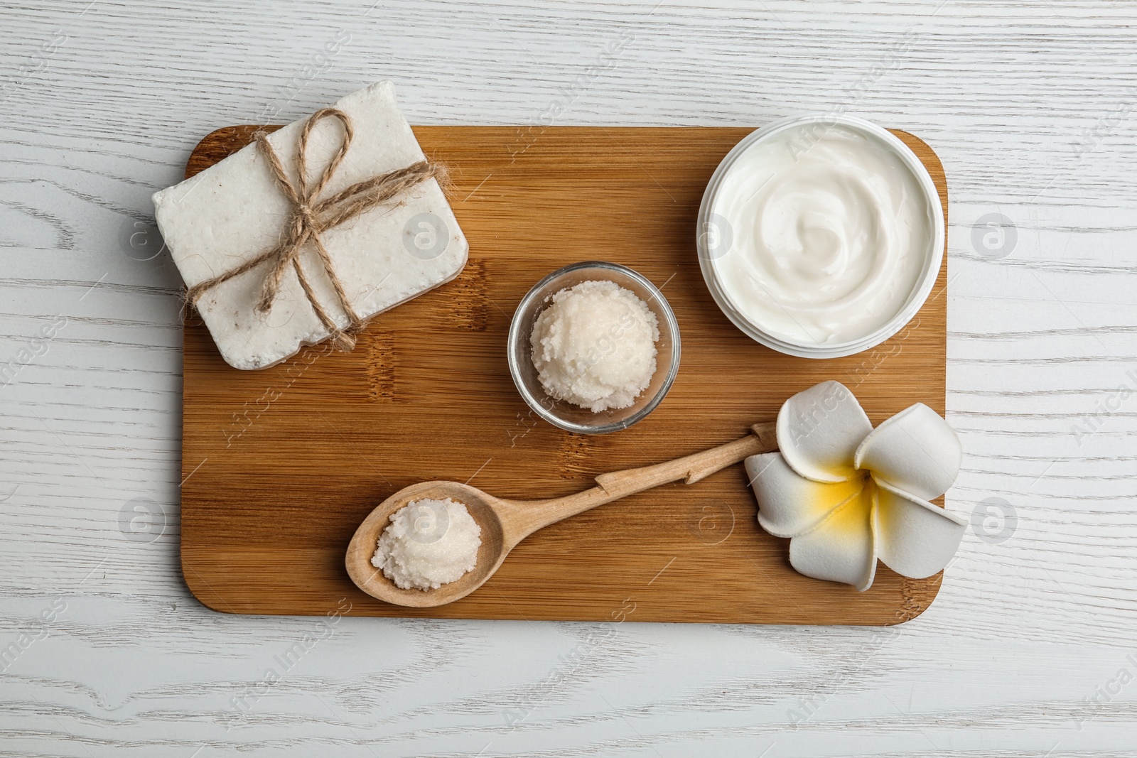 Photo of Board with cosmetic products and Shea butter on table, top view