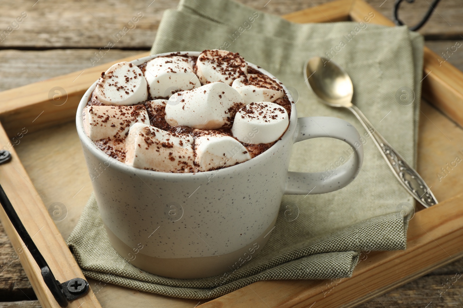 Photo of Delicious hot chocolate with marshmallows and cocoa powder on table, closeup