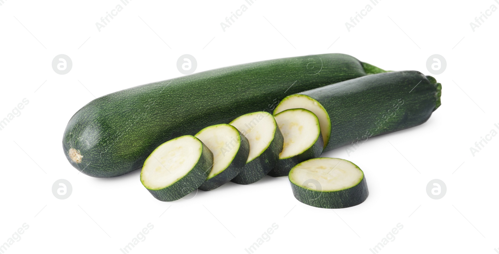 Photo of Cut and whole green ripe zucchini isolated on white