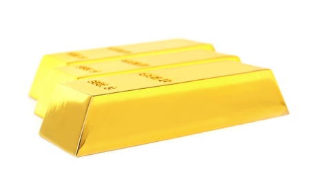 Photo of Precious shiny gold bars on white background