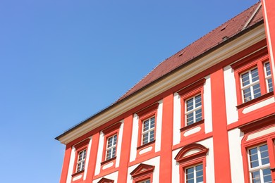 Photo of Beautiful building with red roof against blue sky, low angle view