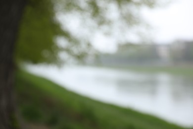 Blurred view of park and river on grey day. Bokeh effect