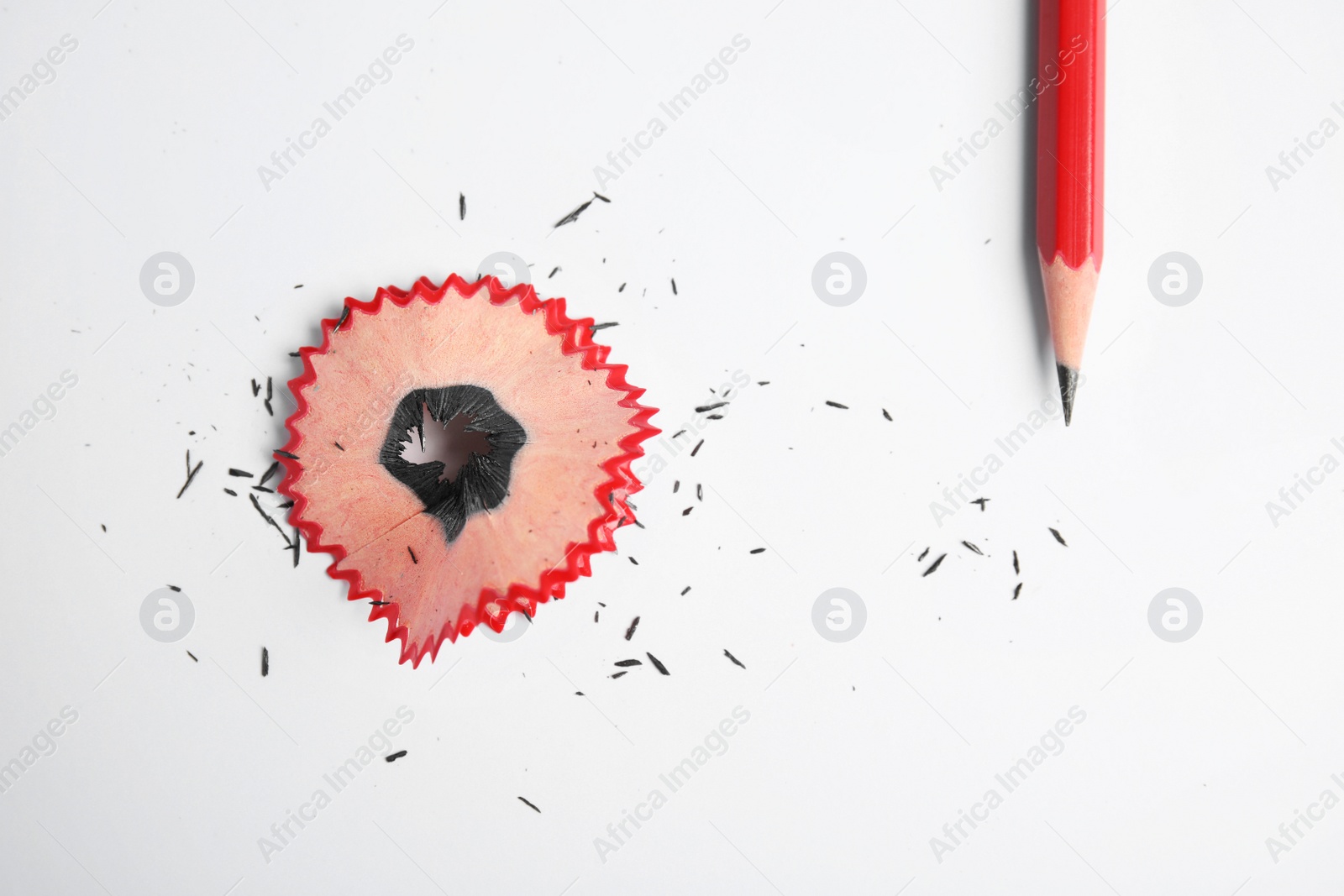 Photo of Pencil and shaving on white background, top view