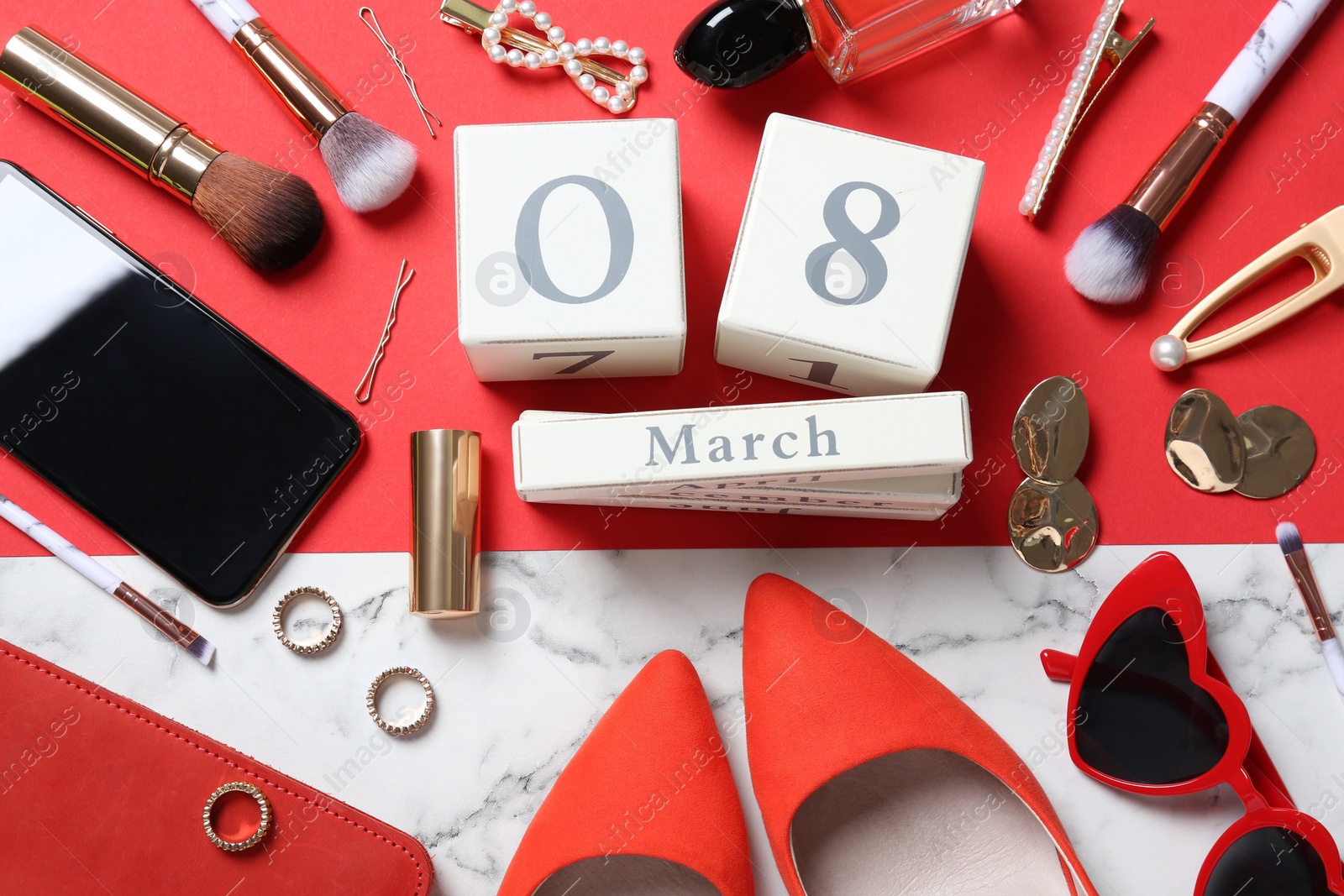 Photo of Flat lay composition with wooden block calendar, smartphone and women's accessories on color background. 8th of March celebration