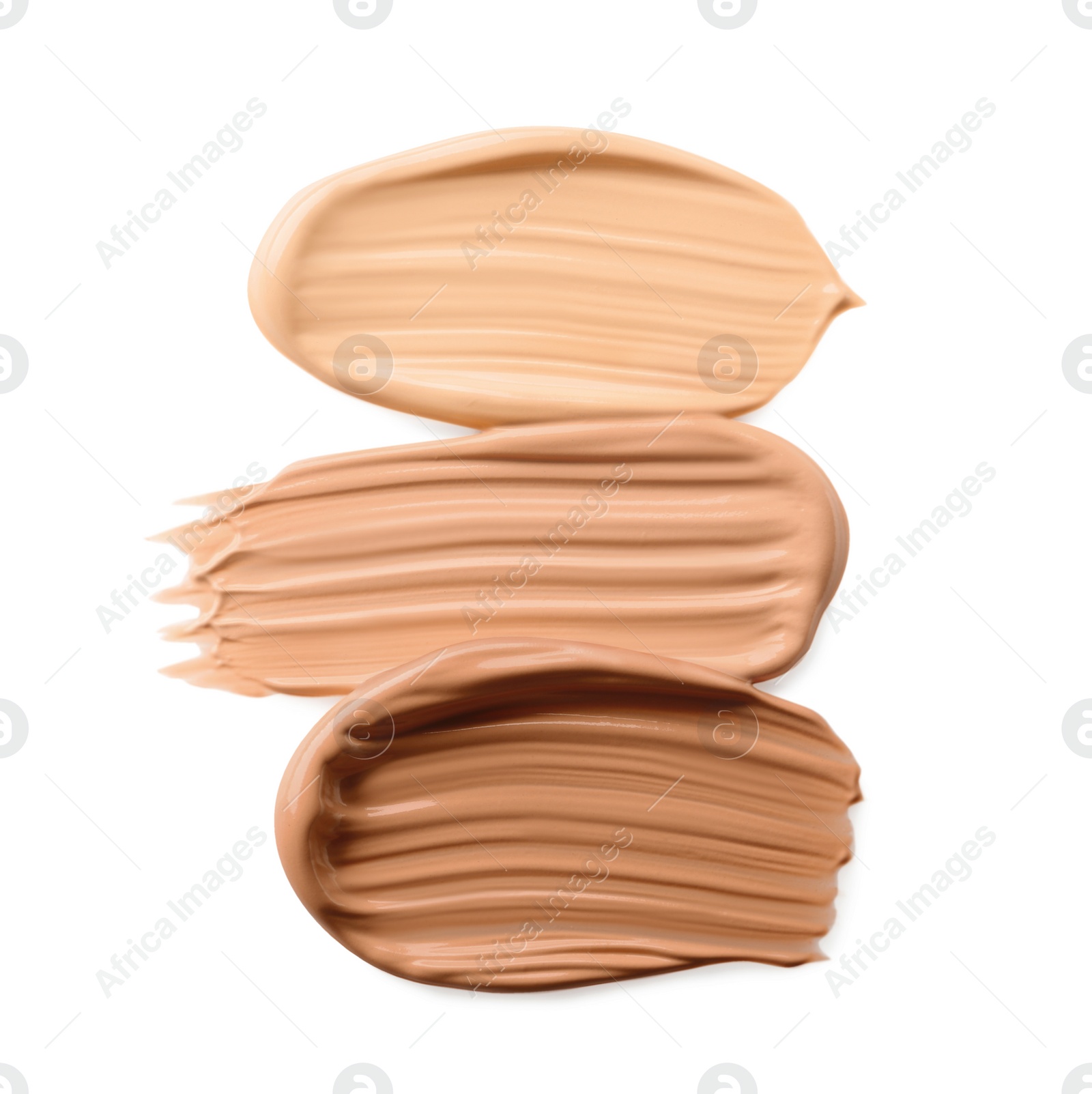 Photo of Samples of liquid skin foundations on white background, top view