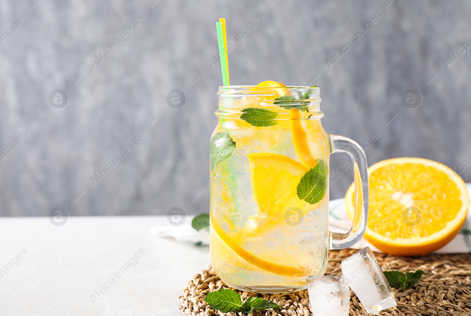 Photo of Delicious refreshing drink on light table. Space for text