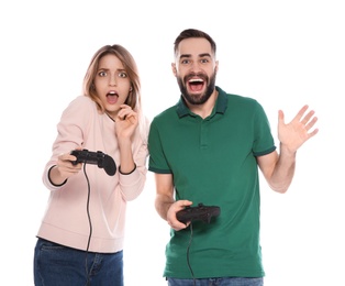 Emotional couple playing video games with controllers isolated on white
