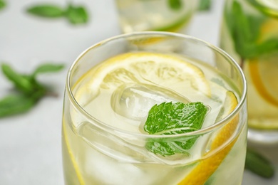 Glass of refreshing lemonade on table, closeup. Summer drink