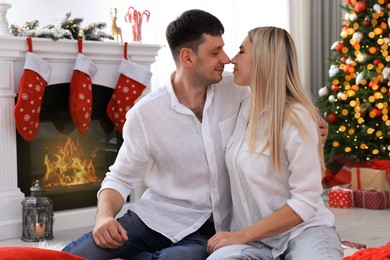 Photo of Lovely couple in room decorated for Christmas