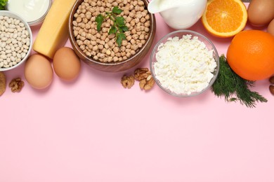 Photo of Food high in calcium. Flat lay composition with different products on pink background ,space for text