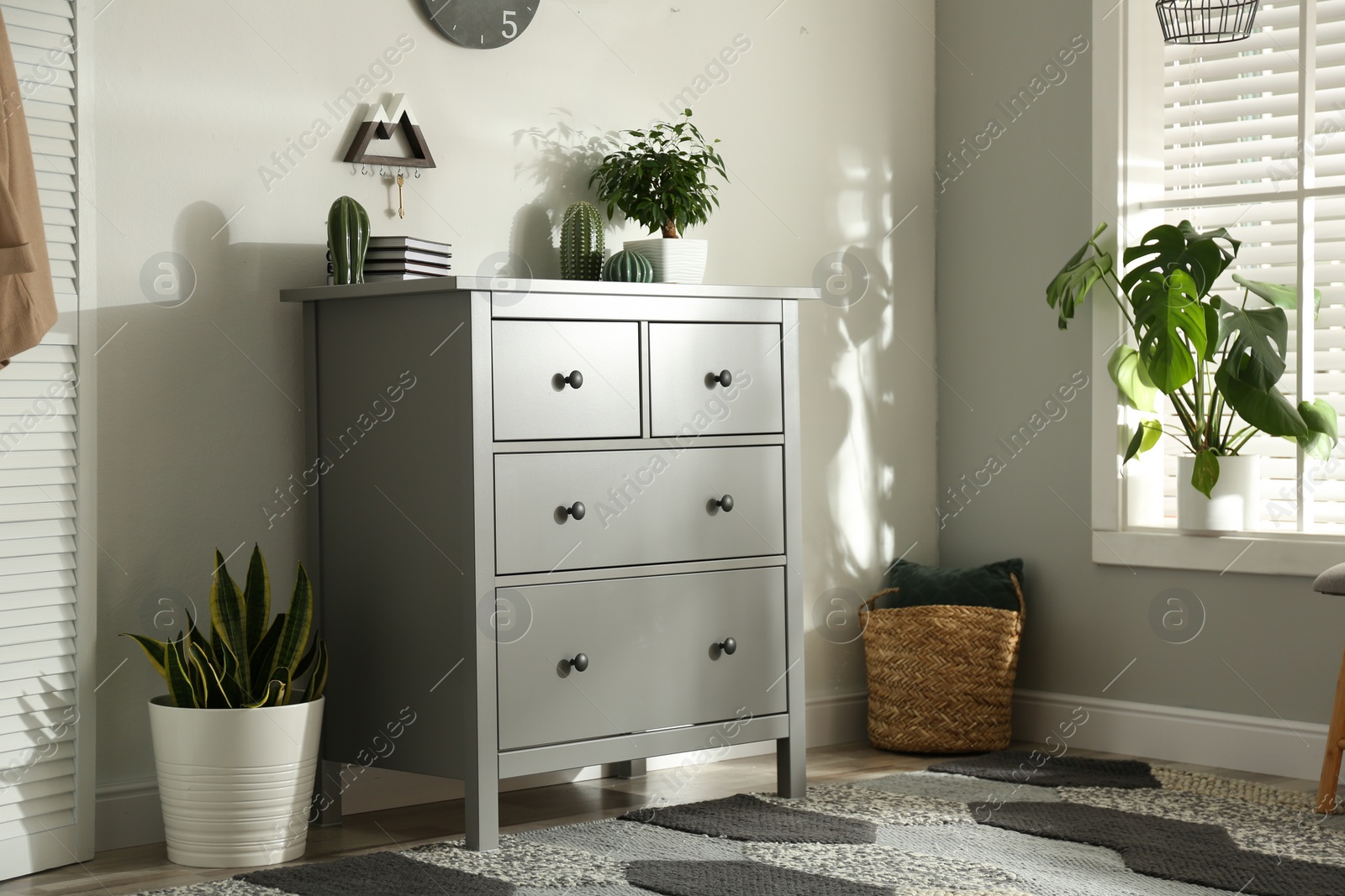 Photo of Grey chest of drawers in stylish room interior