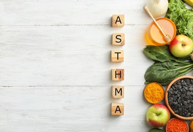 Photo of Natural products and cubes with space for text on wooden background. Home remedies for asthma