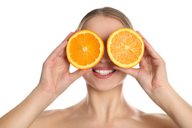 Young woman with cut orange on white background. Vitamin rich food