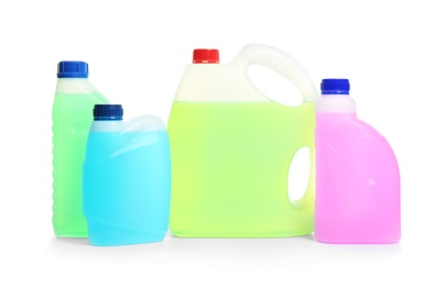 Photo of Plastic canisters with different liquids for car on white background