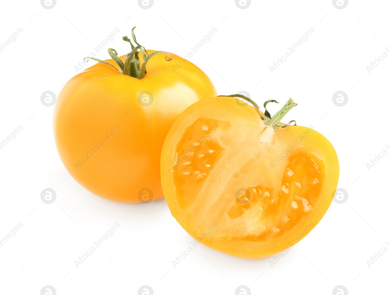 Photo of Cut and whole yellow tomatoes on white background