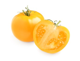 Photo of Cut and whole yellow tomatoes on white background