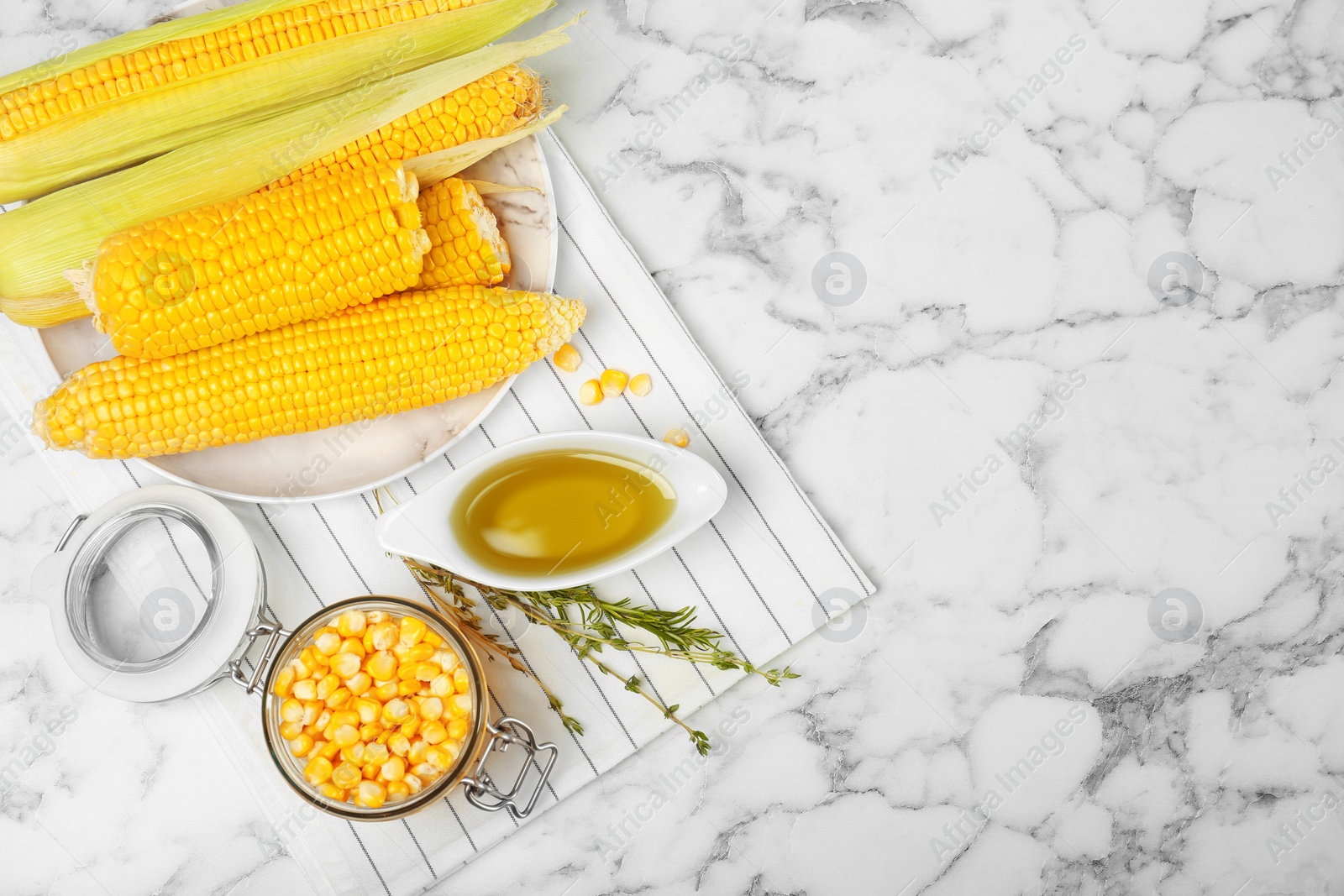 Photo of Flat lay composition with fresh corn oil on marble table