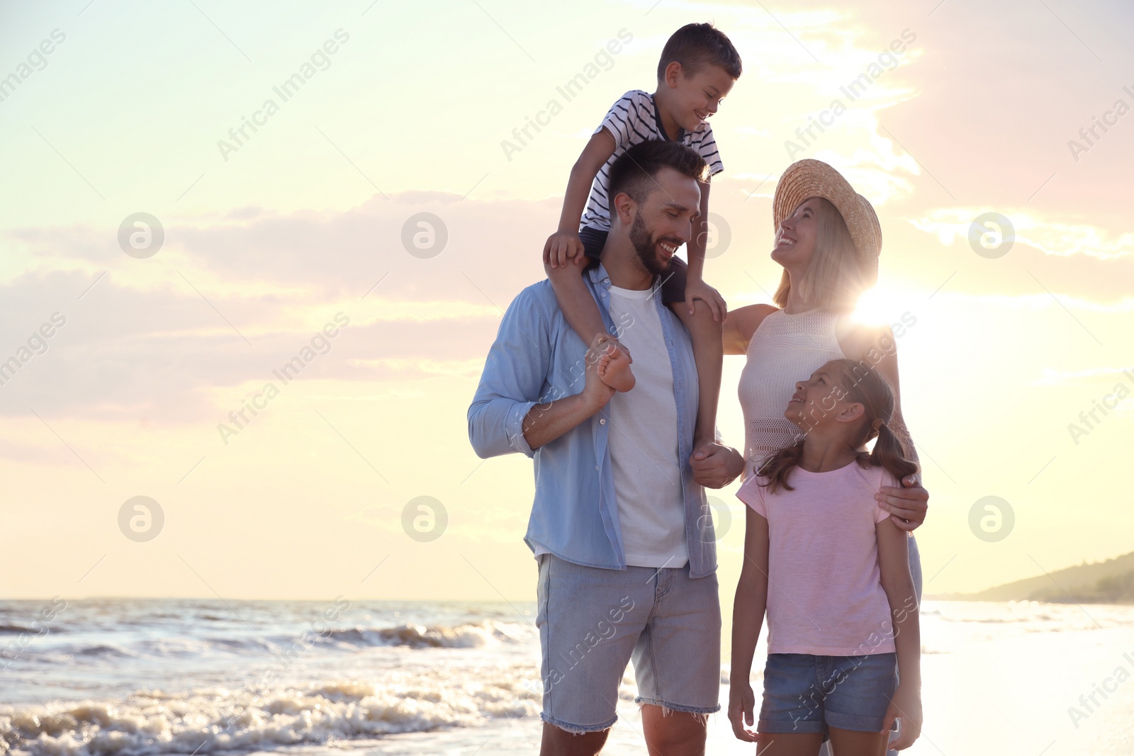 Photo of Happy family on beach near sea. Summer vacation