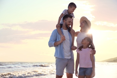 Happy family on beach near sea. Summer vacation