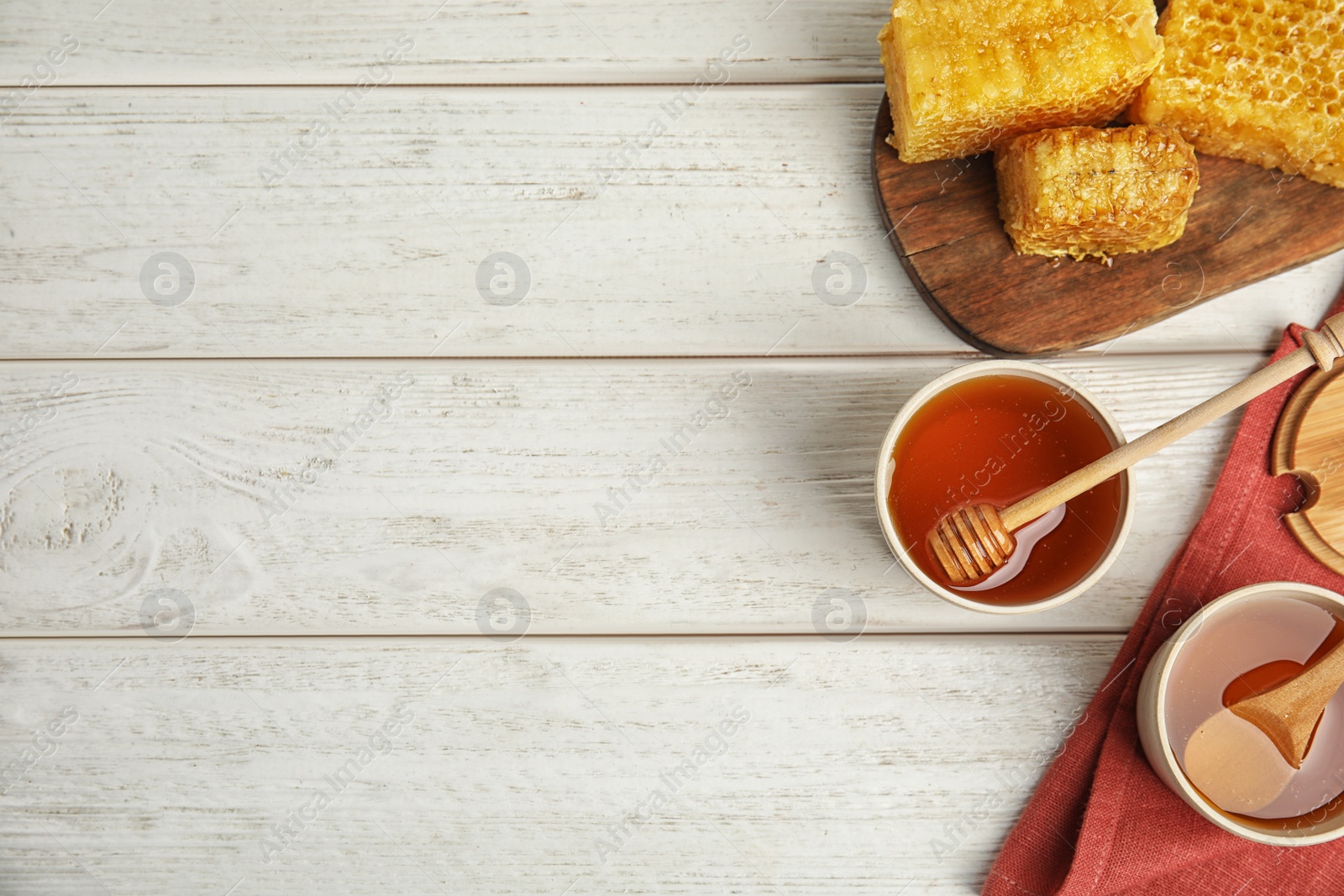 Photo of Flat lay composition with delicious honey on white wooden table. Space for text