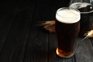 Photo of Glass of delicious kvass on wooden table. Space for text