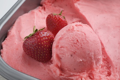 Photo of Scoop of delicious strawberry ice cream with fresh berries, closeup