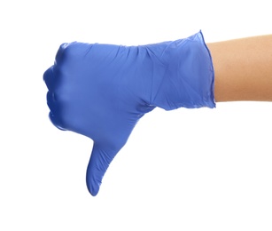 Photo of Woman in blue latex gloves showing thumb down gesture on white background, closeup of hand