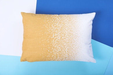 Photo of Soft decorative pillow on color background, top view