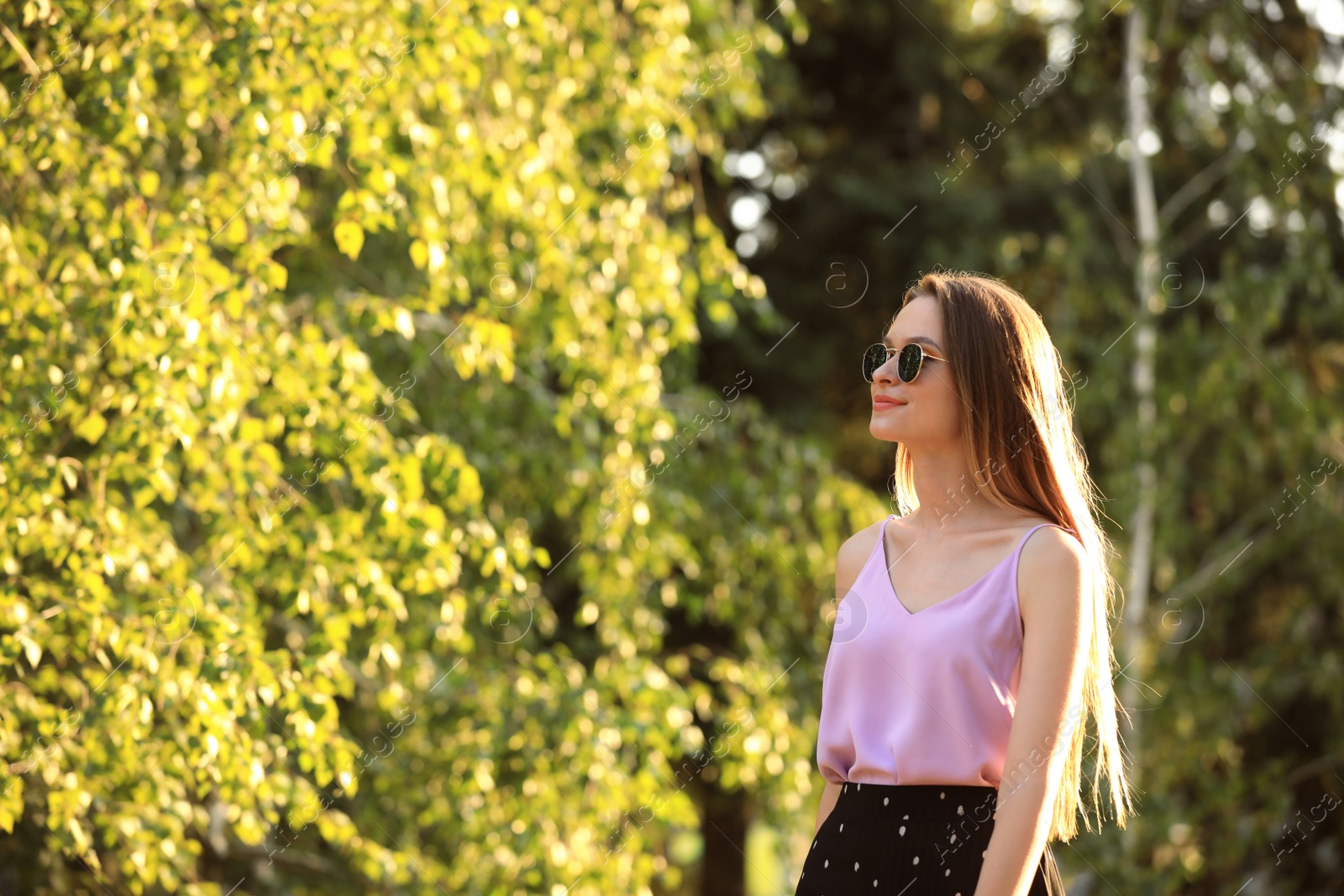 Photo of Beautiful young woman in park on sunny day