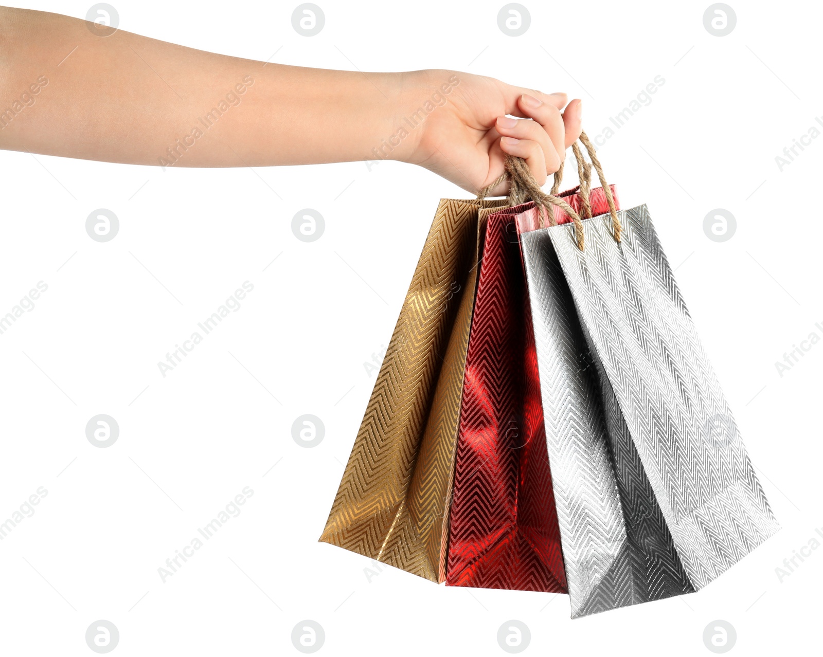 Photo of Woman holding paper shopping bags on white background, closeup. Space for design