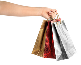 Photo of Woman holding paper shopping bags on white background, closeup. Space for design