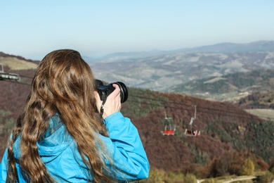 Photo of Professional nature photographer taking photo of mountain landscape
