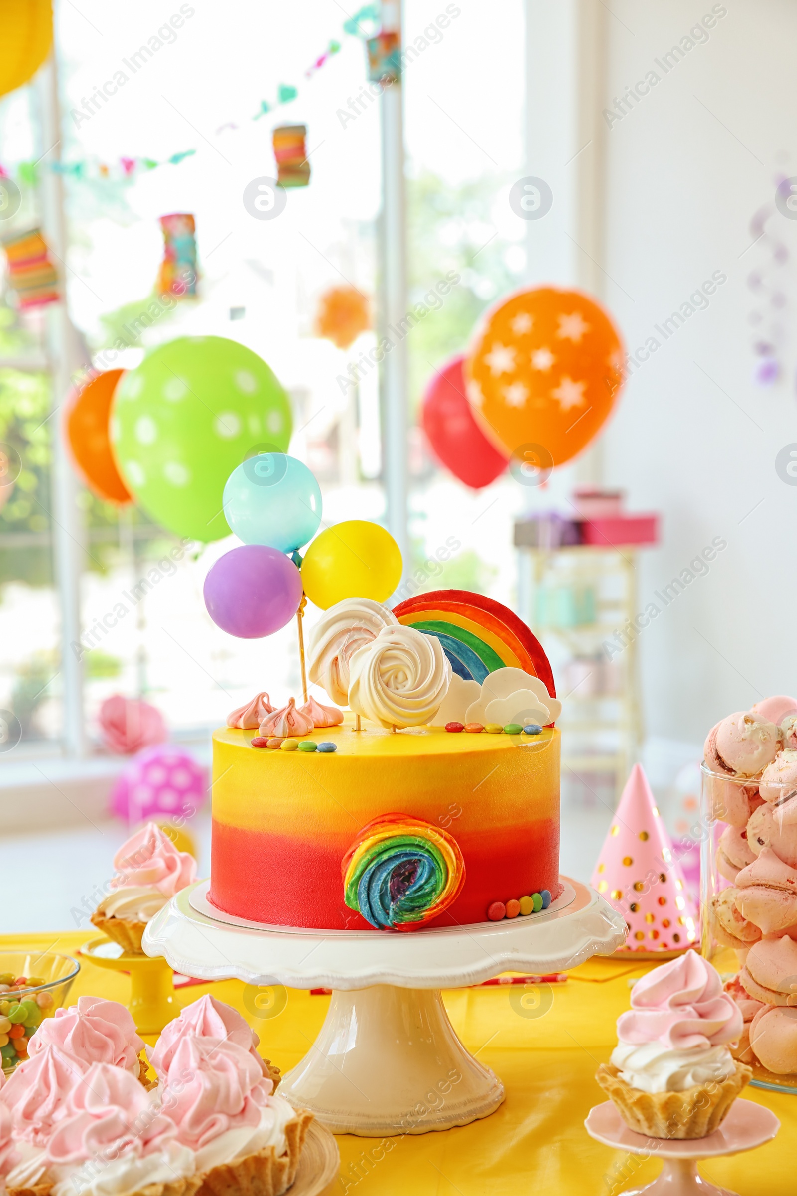 Photo of Table with birthday cake and delicious treats indoors