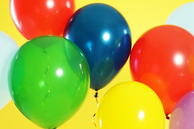 Photo of Bright balloons on color background. Celebration time