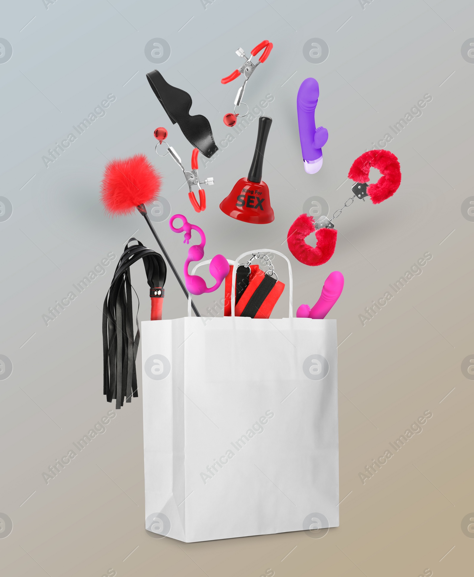 Image of DIfferent sex toys and accessories falling into paper shopping bag on color background