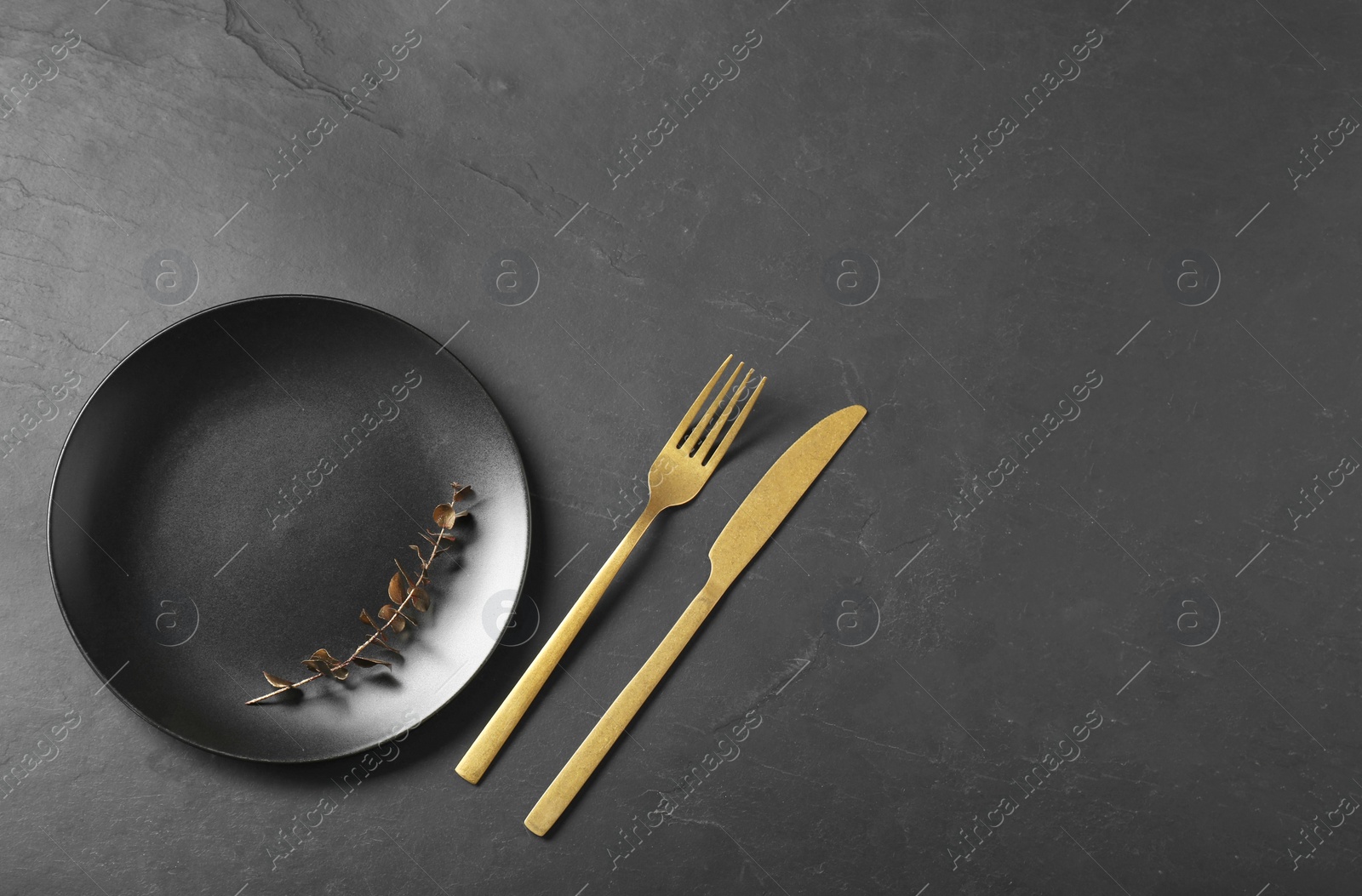 Photo of Stylish setting with elegant cutlery on grey textured table, flat lay. Space for text